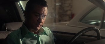 Movie still from “Casino” (1995), directed by Martin Scorsese – A person smoking a cigarette in a room; Medium shot, Low angle