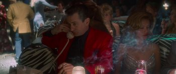 Movie still from “Casino” (1995), directed by Martin Scorsese – A man in a red jacket talking on a phone; Medium shot, High angle