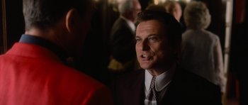 Movie still from “Casino” (1995), directed by Martin Scorsese – A person wearing a suit and tie; Close Up shot, Over the shoulder angle