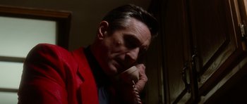 Movie still from “Casino” (1995), directed by Martin Scorsese – A man in a red jacket talking on a phone; Close Up shot, Low angle
