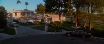 Movie still from “Casino” (1995), directed by Martin Scorsese – A car is parked in front of a house; Extreme Wide shot, High angle