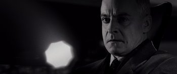 Movie still from “Casino Royale” (2006), directed by Martin Campbell – Black and white photograph of a man in a suit; Close Up shot, Low angle