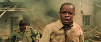 Movie still from “Casino Royale” (2006), directed by Martin Campbell – A man with a bandage on his face is standing in front of smoke; Close Up shot, Low angle