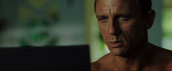 Movie still from “Casino Royale” (2006), directed by Martin Campbell – A man's face as he looks at the camera; Close Up shot, Over the shoulder angle