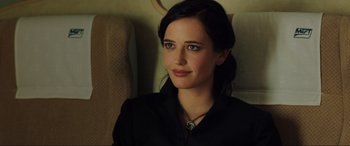 Movie still from “Casino Royale” (2006), directed by Martin Campbell – A woman sitting in a chair wearing a black shirt; Close Up shot, Over the shoulder angle