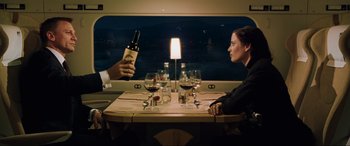 Movie still from “Casino Royale” (2006), directed by Martin Campbell – A man and a woman sitting at a dinner table with wine; Medium shot, High angle