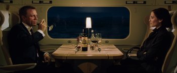 Movie still from “Casino Royale” (2006), directed by Martin Campbell – A bottle of wine on the table; Wide shot, High angle