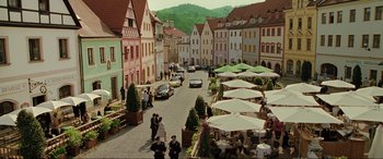 Movie still from “Casino Royale” (2006), directed by Martin Campbell – People are walking down a street in a european city; Extreme Wide shot, High angle