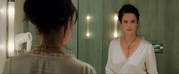 Movie still from “Casino Royale” (2006), directed by Martin Campbell – A woman looking in the mirror in front of a mirror; Close Up shot, Over the shoulder angle