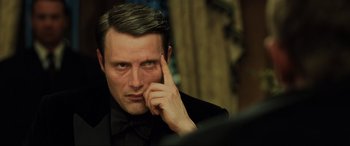 Movie still from “Casino Royale” (2006), directed by Martin Campbell – A person wearing a suit and bow tie; Close Up shot, Over the shoulder angle