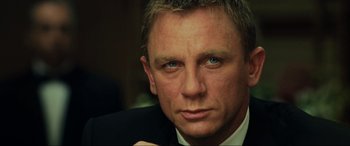Movie still from “Casino Royale” (2006), directed by Martin Campbell – A person wearing a suit and tie; Close Up shot, Over the shoulder angle