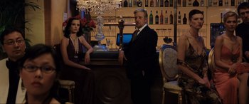 Movie still from “Casino Royale” (2006), directed by Martin Campbell – A man and a woman standing at a bar; Wide shot, Low angle