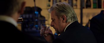 Movie still from “Casino Royale” (2006), directed by Martin Campbell – A person holding a glass of wine; Close Up shot, Over the shoulder angle
