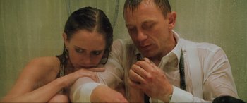 Movie still from “Casino Royale” (2006), directed by Martin Campbell – A man and a woman looking at a cell phone; Close Up shot, High angle