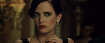 Movie still from “Casino Royale” (2006), directed by Martin Campbell – A beautiful woman with blue eyes wearing a black dress; Close Up shot, Over the shoulder angle