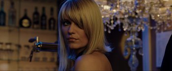 Movie still from “Casino Royale” (2006), directed by Martin Campbell – A woman with blonde hair and blue eye shadow; Close Up shot, Over the shoulder angle