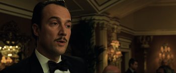 Movie still from “Casino Royale” (2006), directed by Martin Campbell – A man in a suit and bow tie; Close Up shot, Low angle