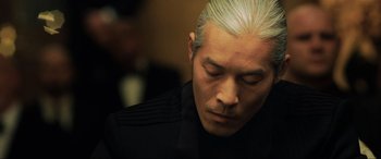 Movie still from “Casino Royale” (2006), directed by Martin Campbell – A person wearing a black shirt; Close Up shot, Low angle