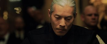 Movie still from “Casino Royale” (2006), directed by Martin Campbell – A person wearing a black shirt; Close Up shot, Low angle