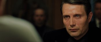 Movie still from “Casino Royale” (2006), directed by Martin Campbell – A person wearing a suit and tie; Close Up shot, Over the shoulder angle