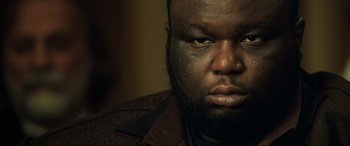 Movie still from “Casino Royale” (2006), directed by Martin Campbell – A person with a beard; Close Up shot, Low angle