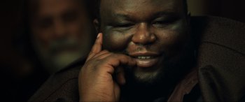 Movie still from “Casino Royale” (2006), directed by Martin Campbell – A person with his hand to his face; Close Up shot, Low angle