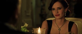 Movie still from “Casino Royale” (2006), directed by Martin Campbell – A woman sitting in front of a lit candle; Close Up shot, Over the shoulder angle