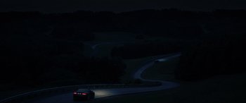 Movie still from “Casino Royale” (2006), directed by Martin Campbell – A car driving down a winding road at night; Extreme Wide shot, High angle