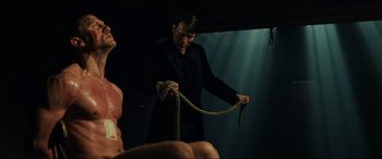Movie still from “Casino Royale” (2006), directed by Martin Campbell – A man holding a rope around a woman's neck; Medium shot, Low angle