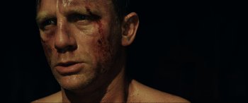 Movie still from “Casino Royale” (2006), directed by Martin Campbell – A person with blood all over his face; Close Up shot, Over the shoulder angle