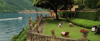 Movie still from “Casino Royale” (2006), directed by Martin Campbell – A man sitting on a chair in the middle of a yard; Extreme Wide shot, High angle