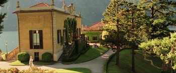 Movie still from “Casino Royale” (2006), directed by Martin Campbell – A garden area with stairs leading up to a building; Extreme Wide shot, High angle
