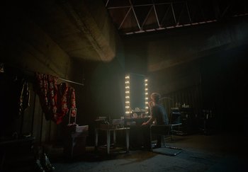 A man sitting in front of a mirror in a room