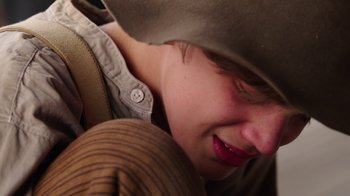 Movie still from “Catch the Bullet” (2021), directed by Michael Feifer – A person wearing a cowboy hat; Close Up shot, High angle