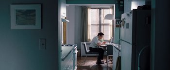 Movie still from “The Secret Life of Walter Mitty” (2013), directed by Ben Stiller – A man sitting at a table in front of a laptop; Wide shot, Low angle