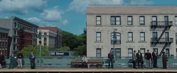 Movie still from “The Secret Life of Walter Mitty” (2013), directed by Ben Stiller – Two men are sitting on a bench on the sidewalk; Extreme Wide shot, Low angle