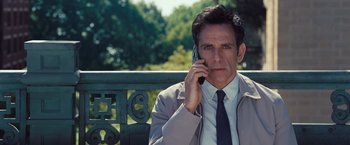 Movie still from “The Secret Life of Walter Mitty” (2013), directed by Ben Stiller – A man sitting on a bench talking on a cell phone; Close Up shot, Over the shoulder angle
