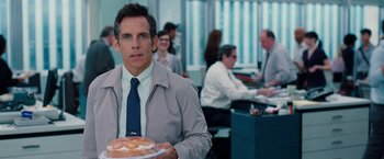 Movie still from “The Secret Life of Walter Mitty” (2013), directed by Ben Stiller – Ben stiller holding a plate of food in front of a group of people; Medium shot, Over the shoulder angle