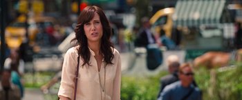 Movie still from “The Secret Life of Walter Mitty” (2013), directed by Ben Stiller – A woman in a white shirt is standing on the sidewalk; Close Up shot, Over the shoulder angle