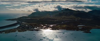 Movie still from “The Secret Life of Walter Mitty” (2013), directed by Ben Stiller – A view of a body of water with a mountain in the background; Extreme Wide shot, High angle