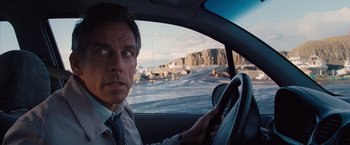Movie still from “The Secret Life of Walter Mitty” (2013), directed by Ben Stiller – A man driving a car on a road; Close Up shot, Over the shoulder angle