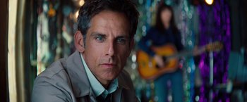 Movie still from “The Secret Life of Walter Mitty” (2013), directed by Ben Stiller – Ben stiller's face with a guitar in the background; Close Up shot, Over the shoulder angle