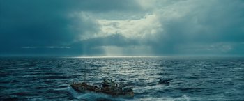 Movie still from “The Secret Life of Walter Mitty” (2013), directed by Ben Stiller – A boat in the middle of the ocean under a cloudy sky; Extreme Wide shot, High angle