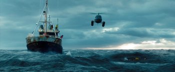Movie still from “The Secret Life of Walter Mitty” (2013), directed by Ben Stiller – A helicopter is flying over a boat in the ocean; Extreme Wide shot, Low angle