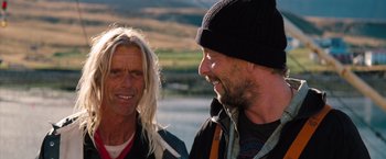 Movie still from “The Secret Life of Walter Mitty” (2013), directed by Ben Stiller – Two men standing next to each other near a body of water; Close Up shot, Over the shoulder angle