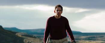 Movie still from “The Secret Life of Walter Mitty” (2013), directed by Ben Stiller – A man in a maroon sweater is holding a skateboard; Medium shot, Low angle