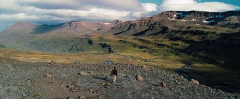 Movie still from “The Secret Life of Walter Mitty” (2013), directed by Ben Stiller – A person is walking on a rocky mountain side; Extreme Wide shot, High angle