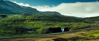 Movie still from “The Secret Life of Walter Mitty” (2013), directed by Ben Stiller – A waterfall in the middle of a lush green hillside; Extreme Wide shot, High angle