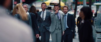 Movie still from “The Secret Life of Walter Mitty” (2013), directed by Ben Stiller – A group of men in business suits walking down a street; Medium shot, Over the shoulder angle