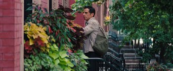 Movie still from “The Secret Life of Walter Mitty” (2013), directed by Ben Stiller – A man with a backpack standing next to a plant; Medium shot, Over the shoulder angle